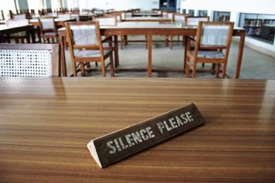 empty library with silence please placard